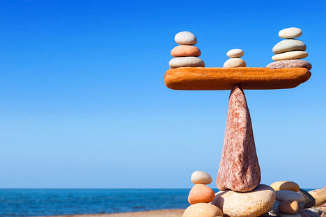 Photo of rocks stacked on a beach, illustrating the article Balanced Living